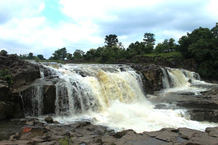 Pochera Waterfall cascading over granite rocks amidst lush green forests in Nirmal, Telangana