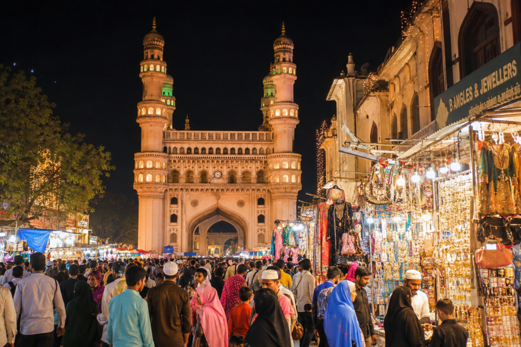 Illuminated Charminar during Ramzan with bustling night markets, worshippers, and festive Eid-ul-Fitr celebrations in Hyderabad, Telangana.