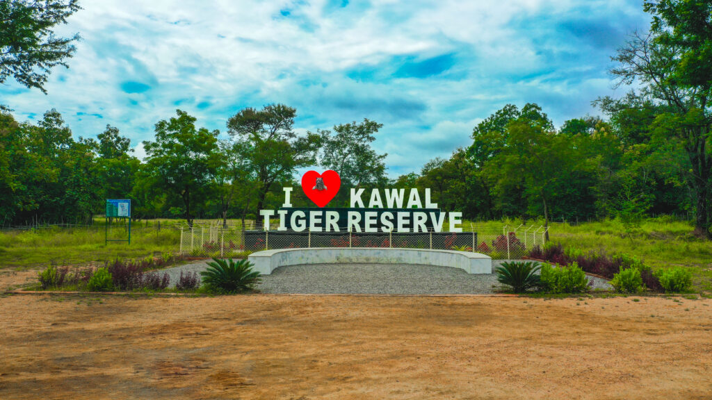 Entrance sign of Kawal Tiger Reserve surrounded by dense forests in Mancherial district, Telangana.